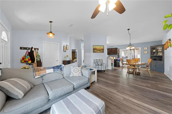 a living room with furniture and a chandelier