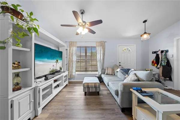 a living room with furniture and a flat screen tv