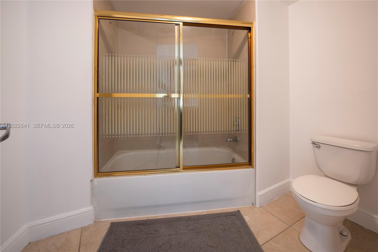 4147 Stirling Road, Unit 105 Dania Beach, FL 33314 - Photo 14 of 16 a bathroom with a toilet and a shower