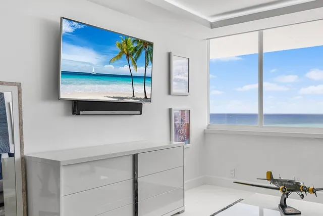 a living room with furniture and painting on the wall