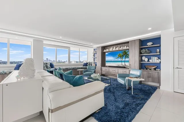 a living room with furniture window and kitchen view