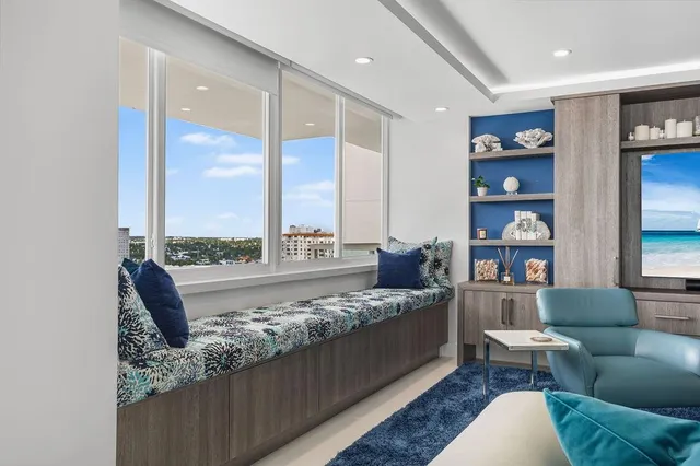 a living room with furniture a flat screen tv and a table