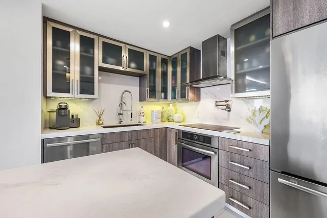 a kitchen with stainless steel appliances granite countertop a stove and cabinets