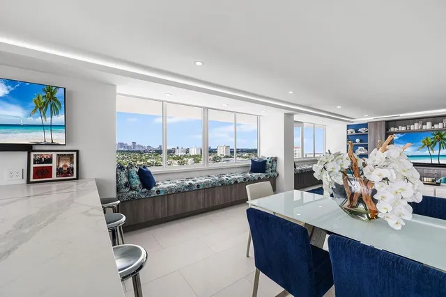 a living room with furniture and a view of kitchen