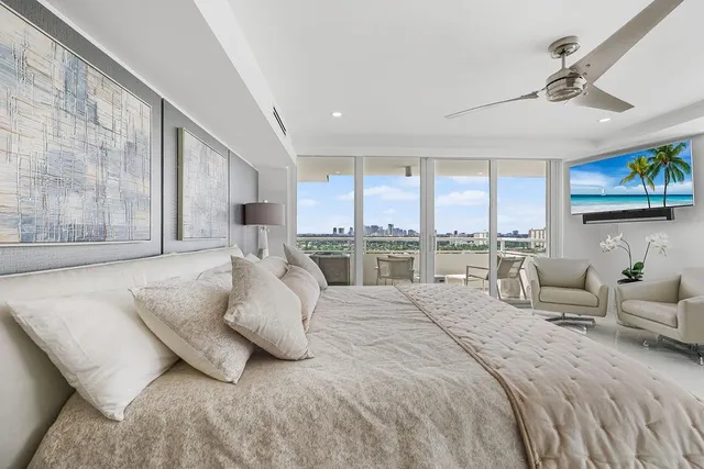 a bedroom with a large bed and a chandelier