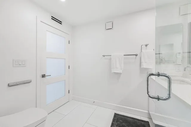 a spacious bedroom with a large bed and a couch