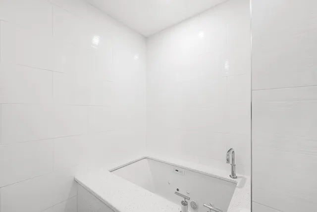 a large bedroom with a bed couches and flat tv screen