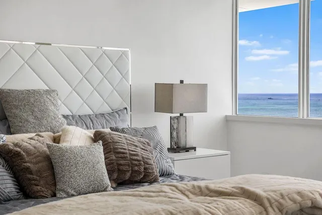 a view of an empty room and closet with wooden floor