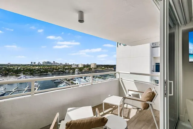 a bathroom with a granite countertop sink a mirror a glass door a toilet and shower
