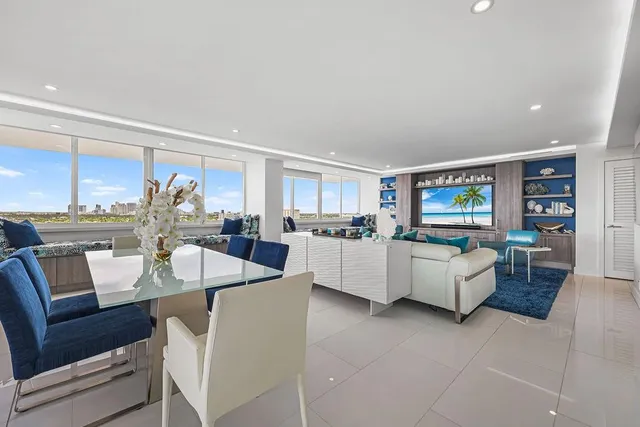 a living room with furniture a flat screen tv and a window