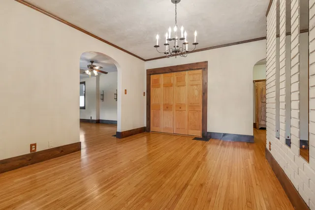a view of livingroom with chandelier and wooden floor
