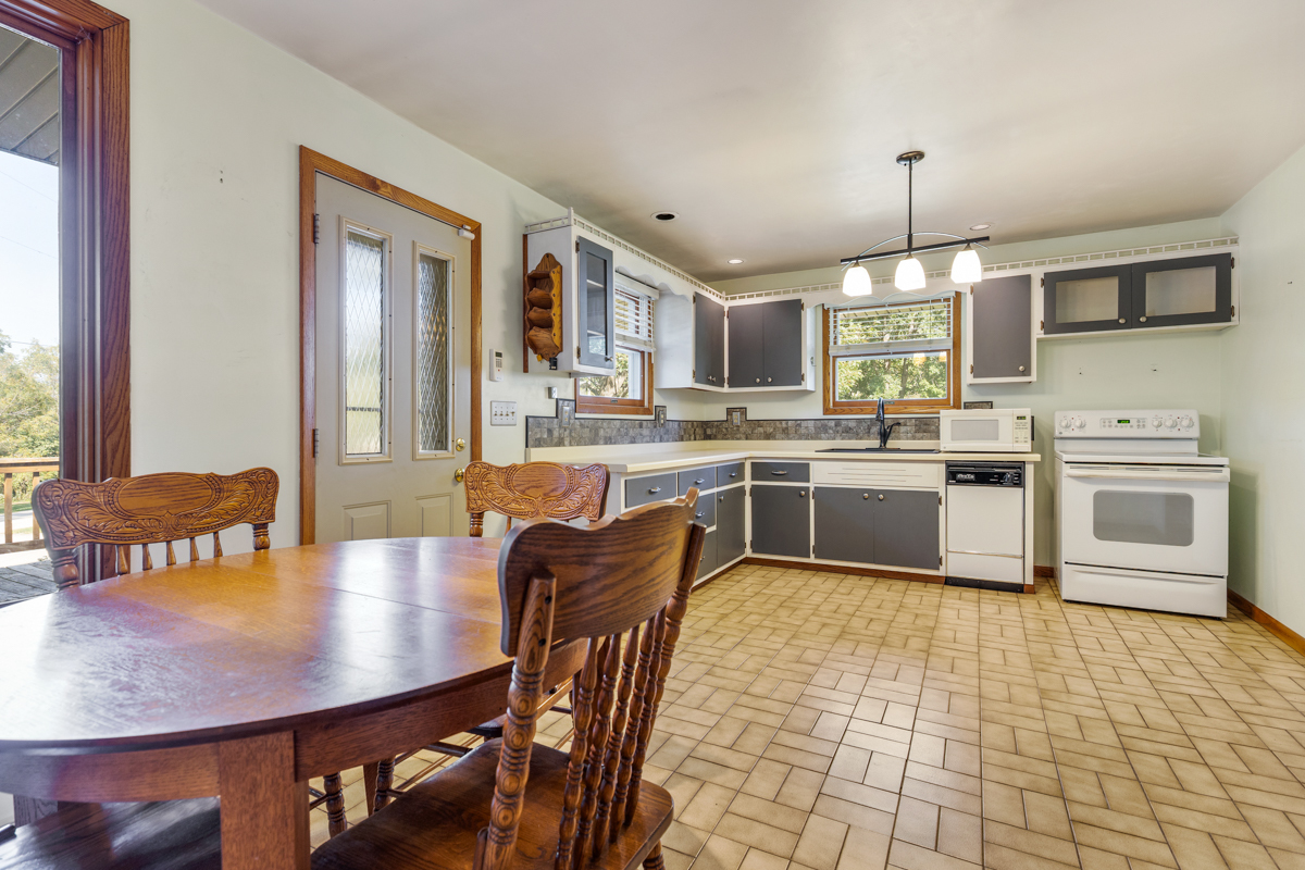 18633 Main Street Mokena, IL 60448 - Photo 16 of 24 a kitchen with stainless steel appliances granite countertop a sink dishwasher a stove a refrigerator with a dining table and chairs