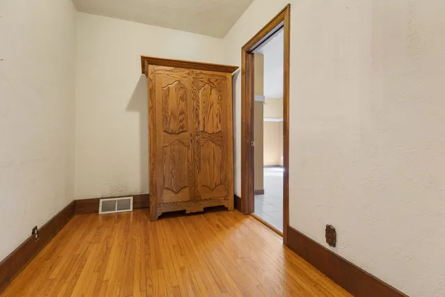 a view of a room with wooden floor