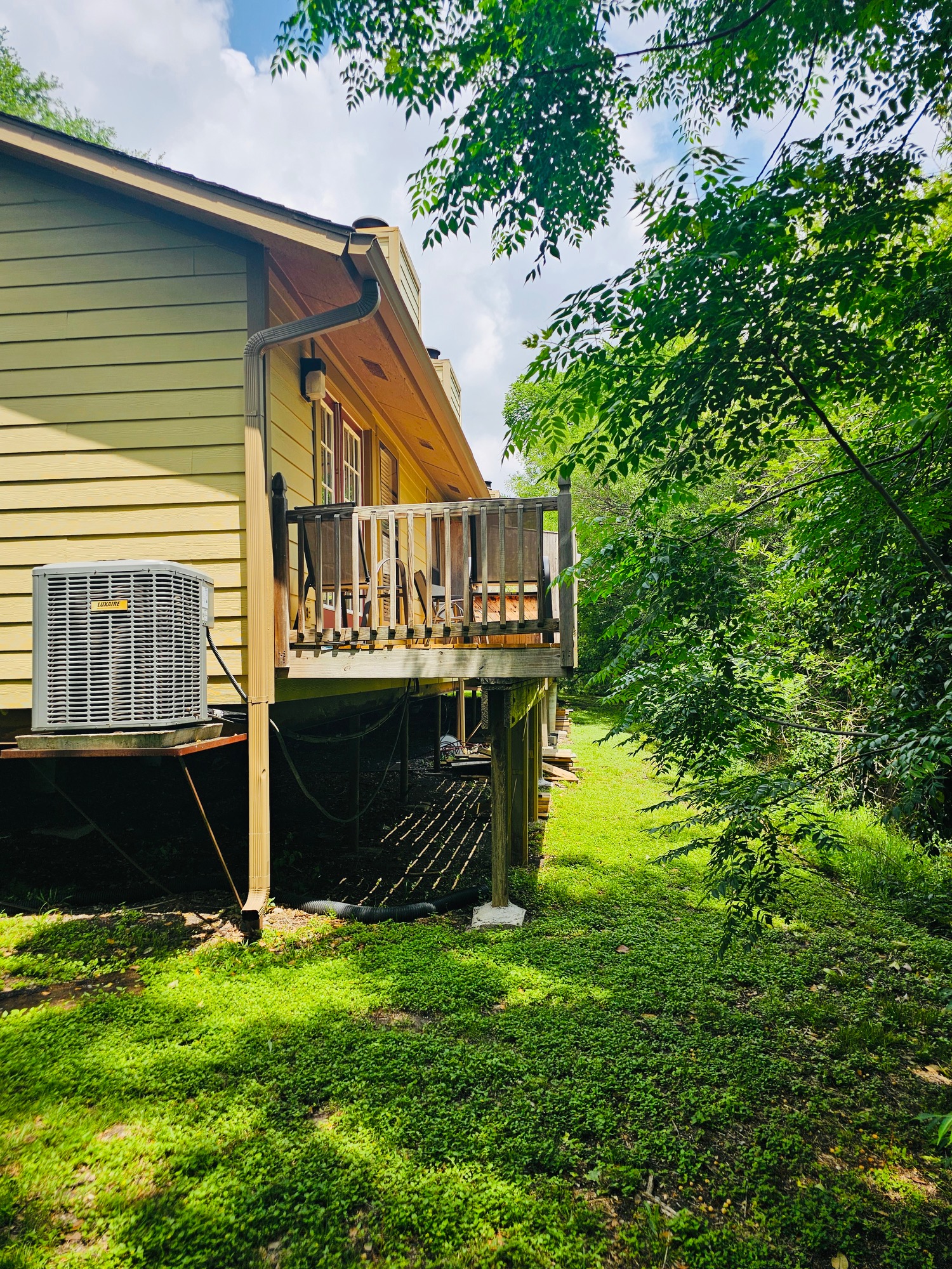 5107 Leralynn Street, Unit 304 Austin, TX 78751 - Photo 24 of 28 Rear view of house with a deck, a yard, a chimney, and central AC unit