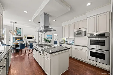 a kitchen with stainless steel appliances granite countertop a stove refrigerator and a microwave
