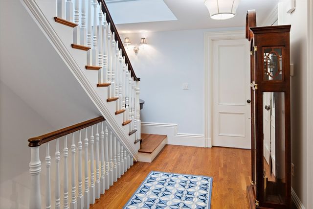 a view of entryway with stairs and wooden floor