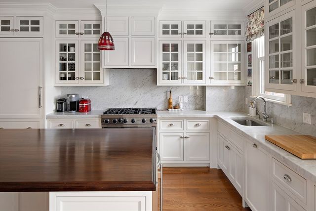 a kitchen with stainless steel appliances granite countertop a sink stove and cabinets