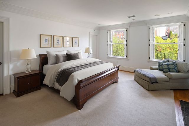 a spacious bedroom with a bed and a couch