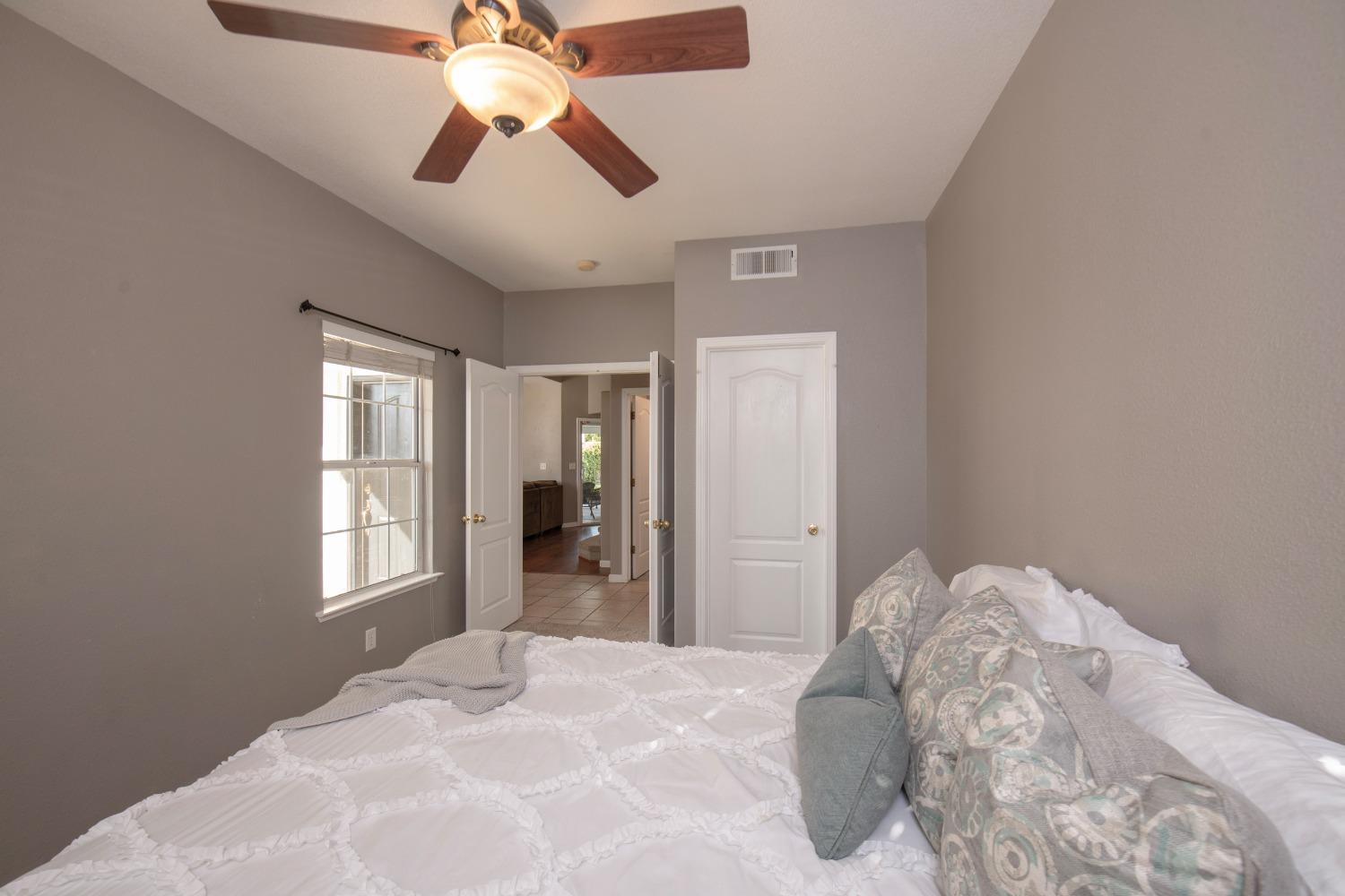 1847 Goshen Avenue Clovis, CA 93611 - Photo 11 of 39 a bedroom with a bed and a chandelier