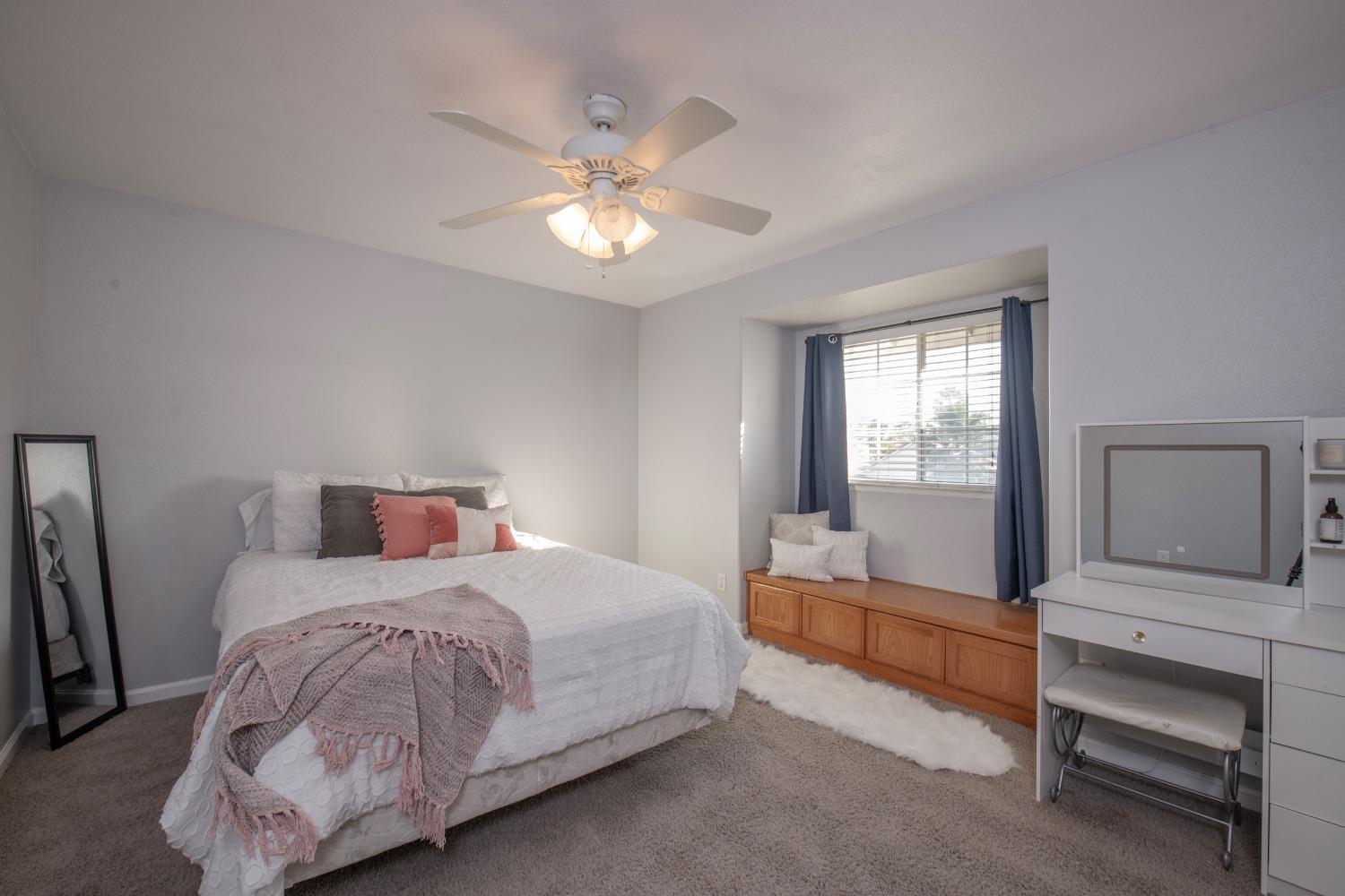 1847 Goshen Avenue Clovis, CA 93611 - Photo 20 of 39 a bedroom with a bed and a chandelier