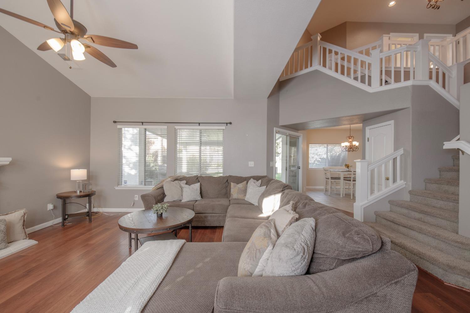 1847 Goshen Avenue Clovis, CA 93611 - Photo 4 of 39 a living room with furniture a chandelier fan and a window