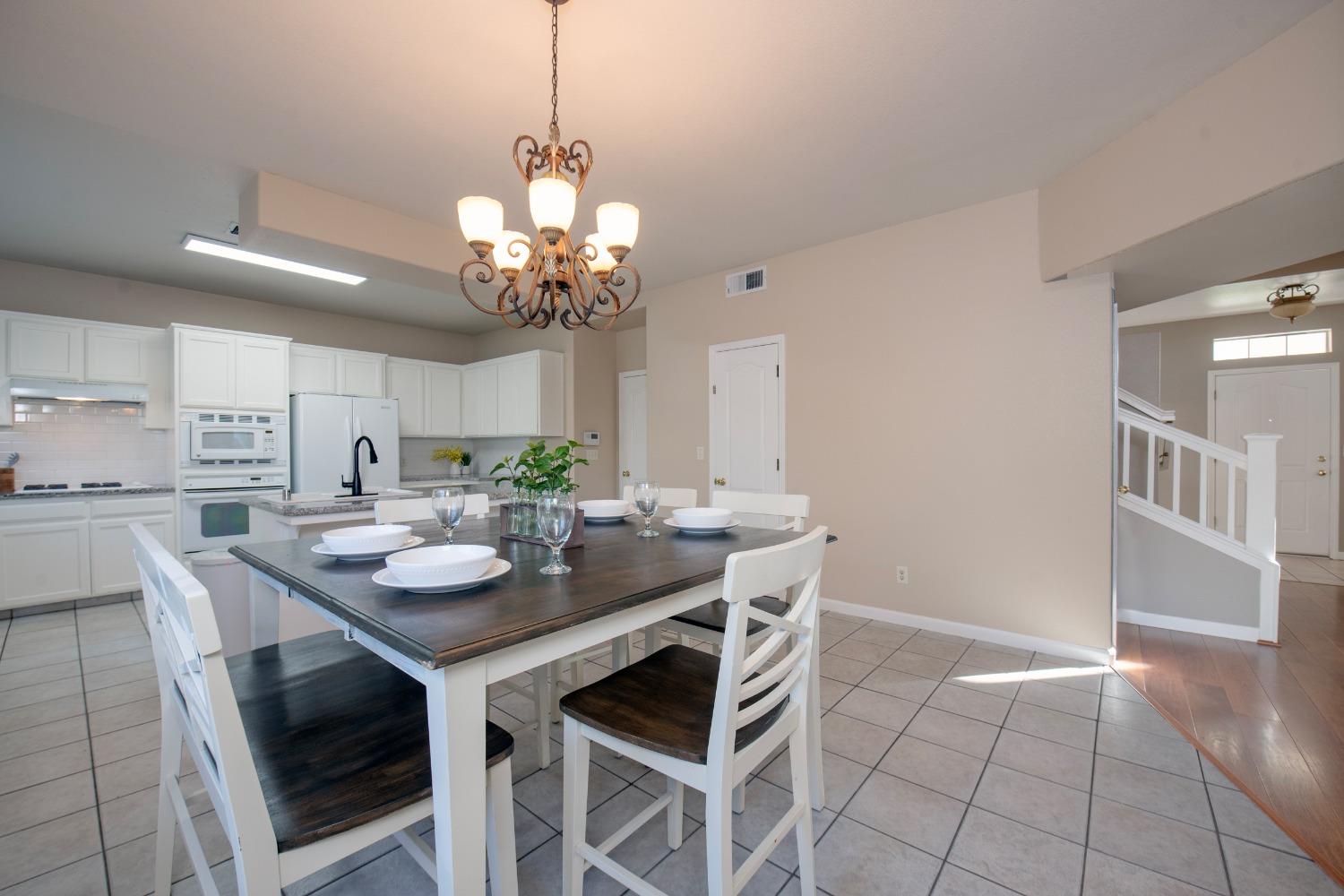 1847 Goshen Avenue Clovis, CA 93611 - Photo 5 of 39 a view of a dining room with furniture and chandelier