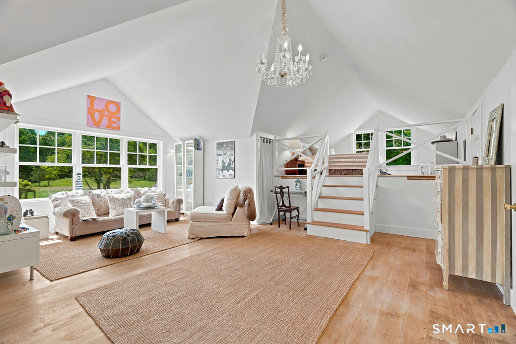 261-1 Grassy Hill Road Lyme, CT 06371 - Photo 24 of 40 With its unique design, generous proportions, sitting area, and loft, this upper-level bedroom is both inviting and versatile.