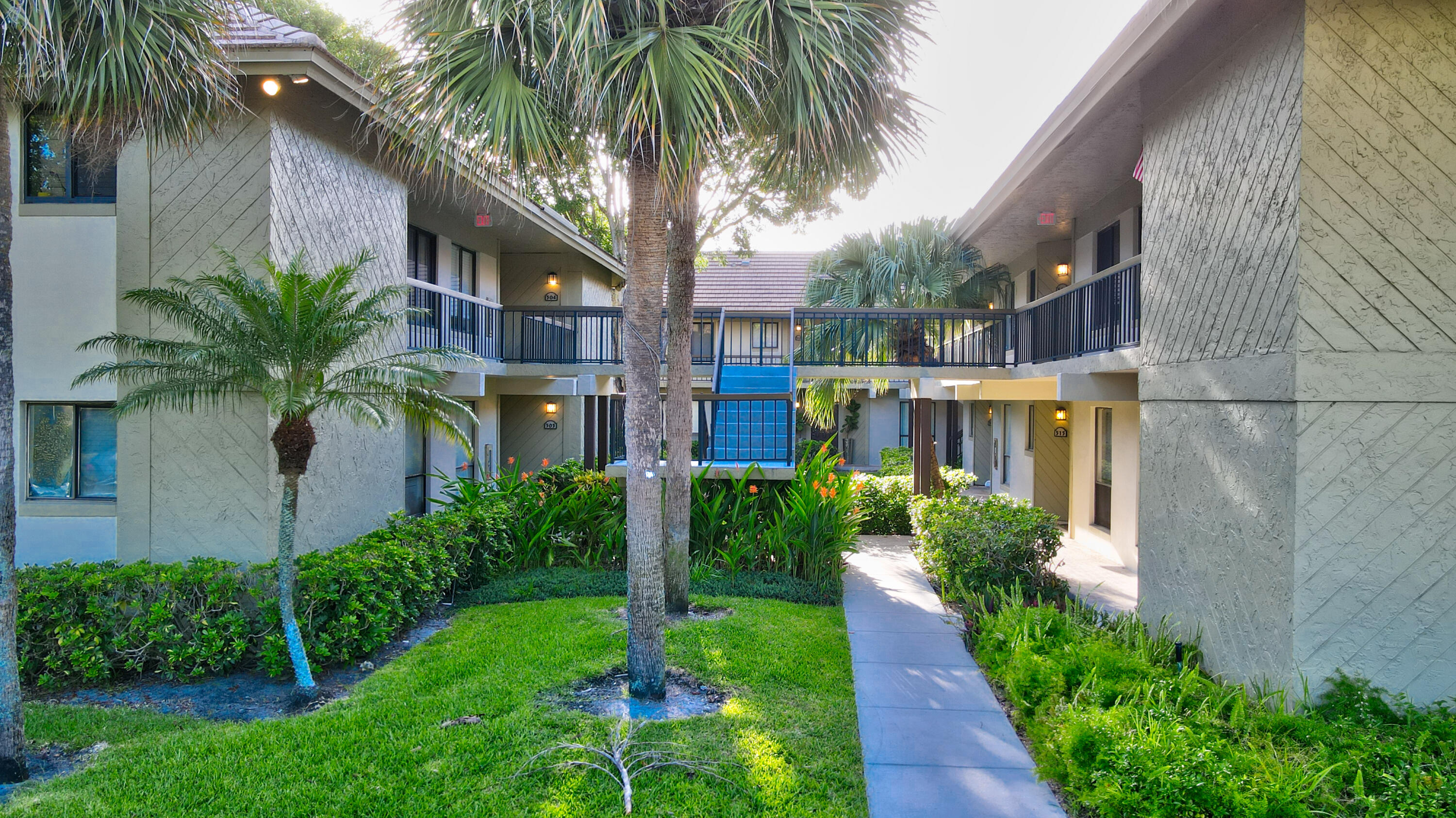 159 Northwest 70th Street, Unit 516 Boca Raton, FL 33487 - Photo 12 of 39 a front view of house with yard and green space