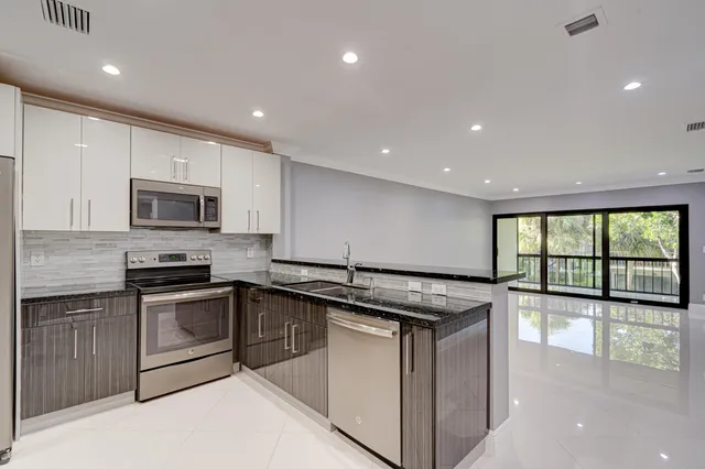 a kitchen with a stove sink and microwave