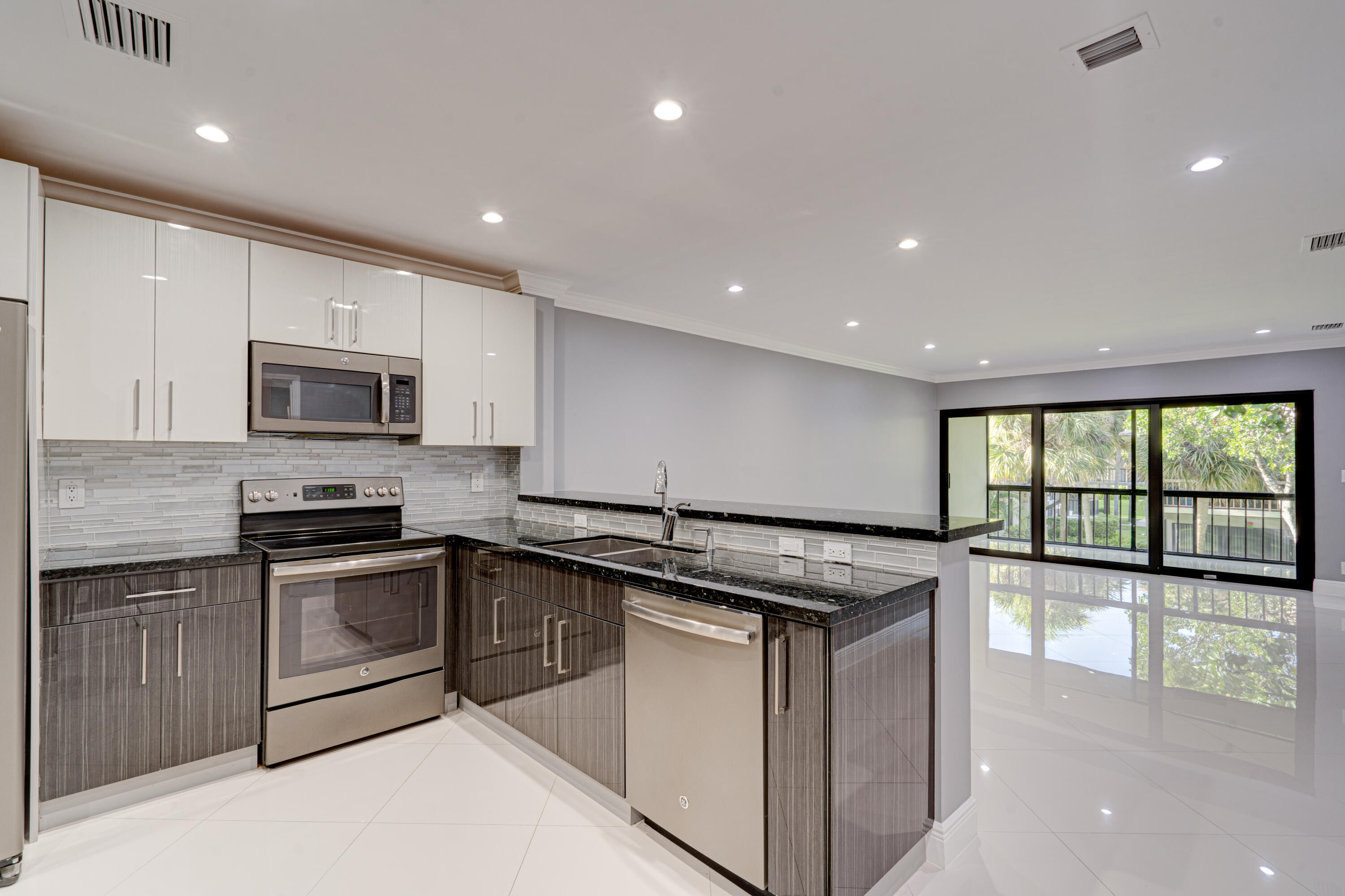 159 Northwest 70th Street, Unit 516 Boca Raton, FL 33487 - Photo 16 of 39 a kitchen with a stove sink and microwave