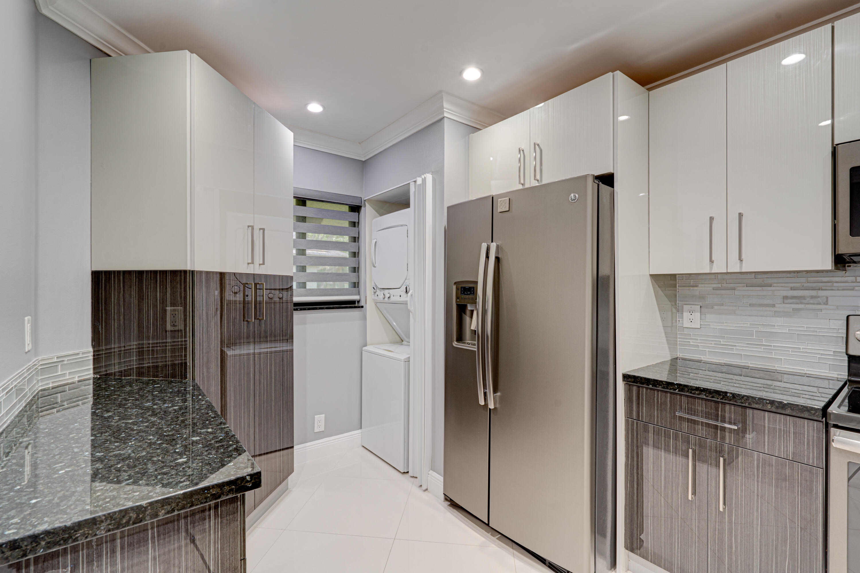 159 Northwest 70th Street, Unit 516 Boca Raton, FL 33487 - Photo 19 of 39 a kitchen with stainless steel appliances granite countertop a refrigerator and a sink