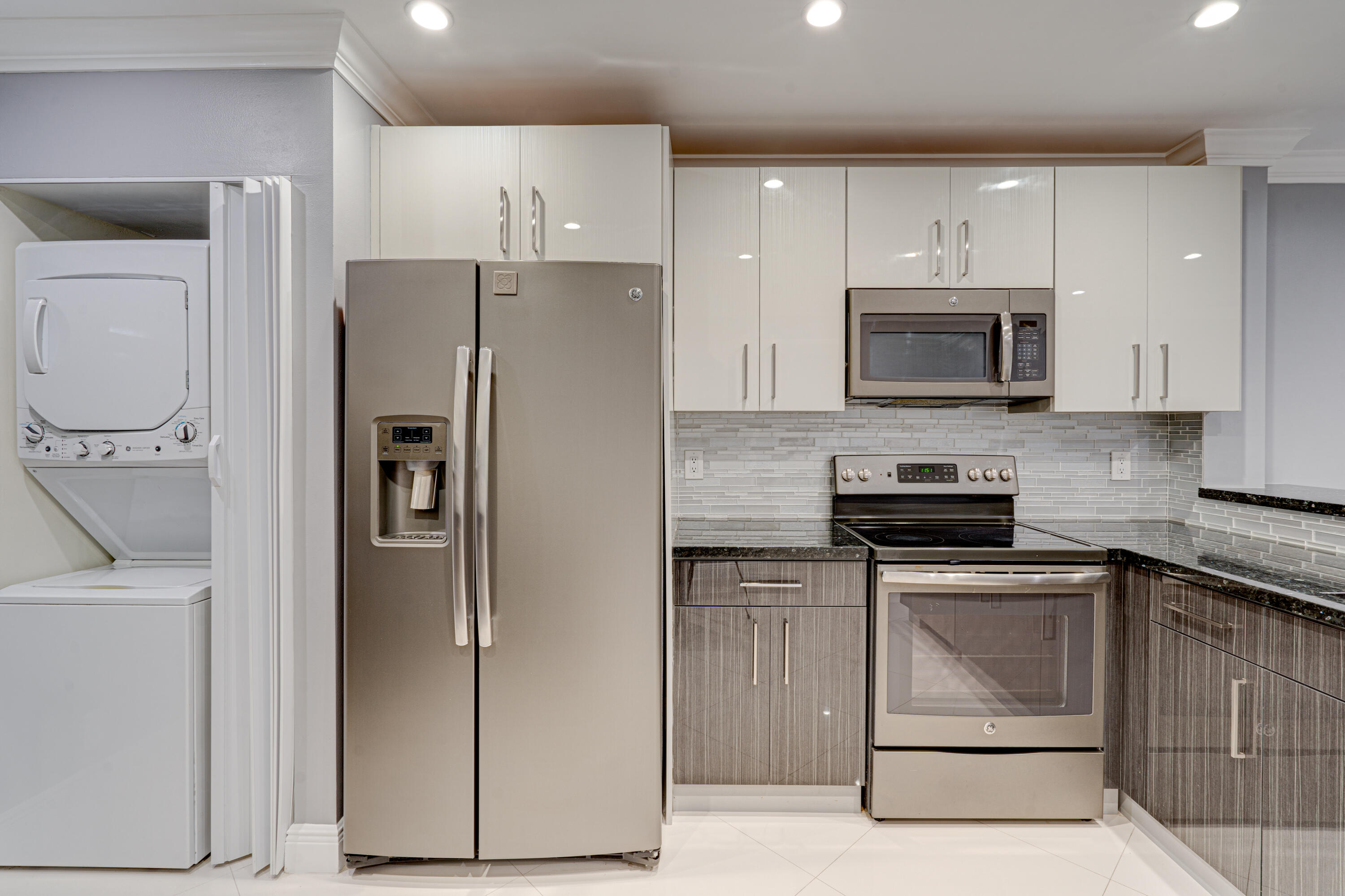 159 Northwest 70th Street, Unit 516 Boca Raton, FL 33487 - Photo 20 of 39 a kitchen with a refrigerator stove and microwave