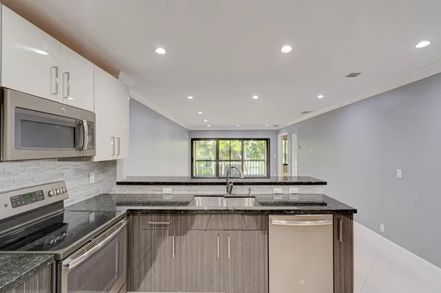 a kitchen with a sink stove and microwave