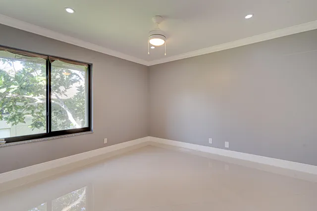 an empty room with closet and mirror