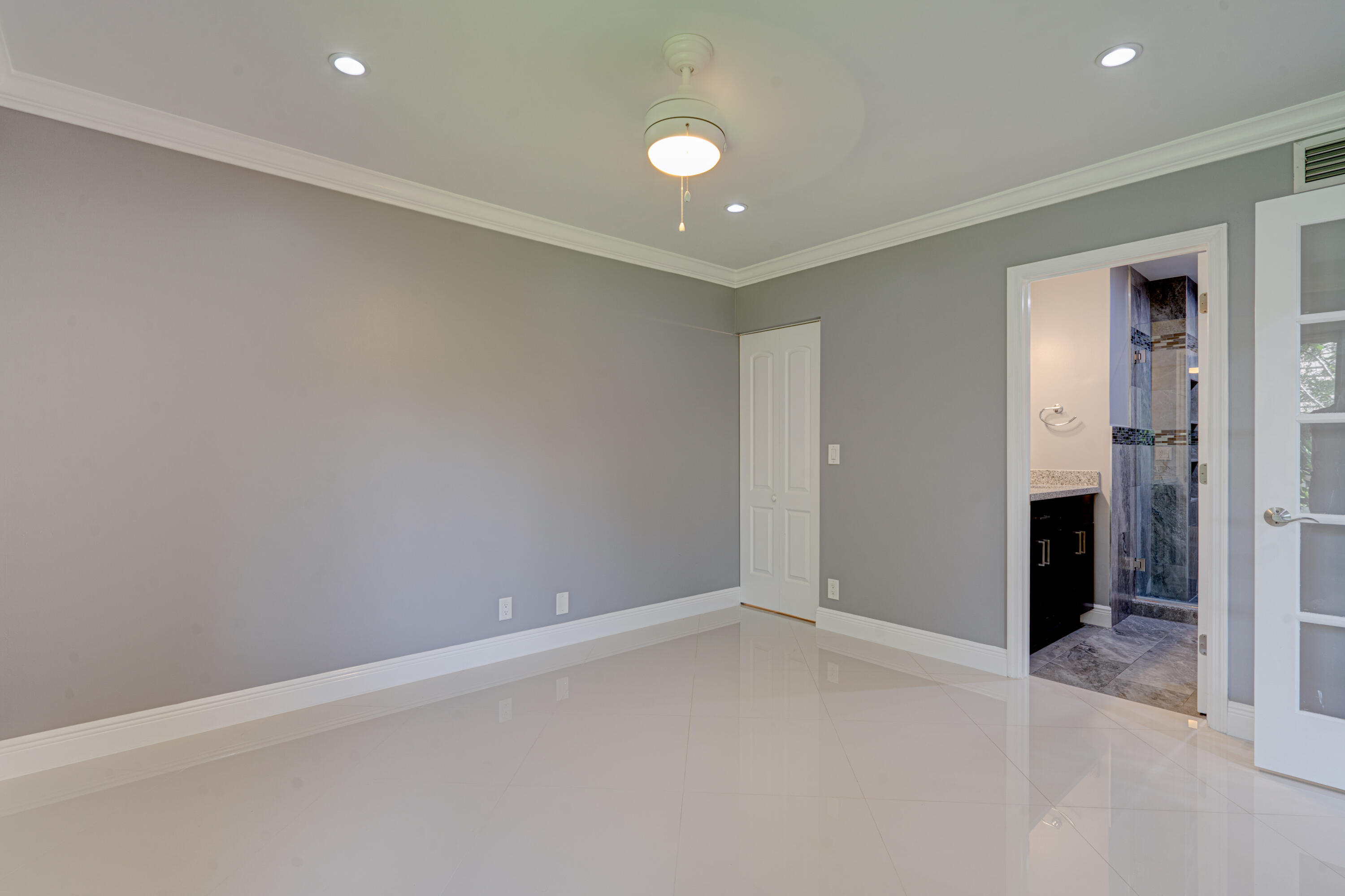 159 Northwest 70th Street, Unit 516 Boca Raton, FL 33487 - Photo 29 of 39 an empty room with closet and mirror