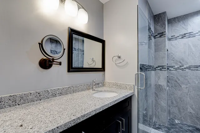 a white toilet sitting next to a shower