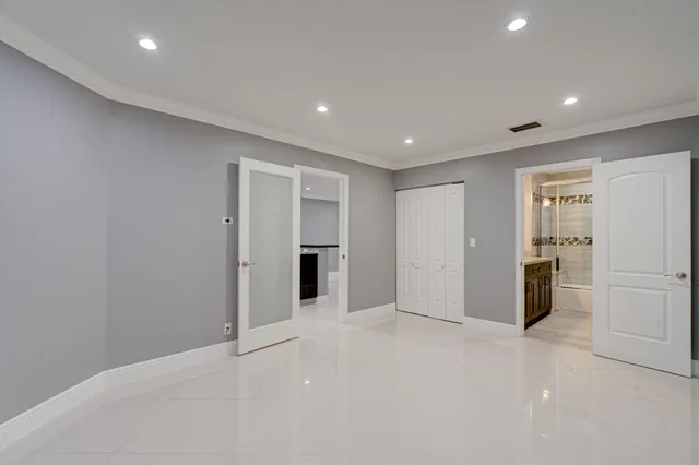 a view of walk in closet with empty racks