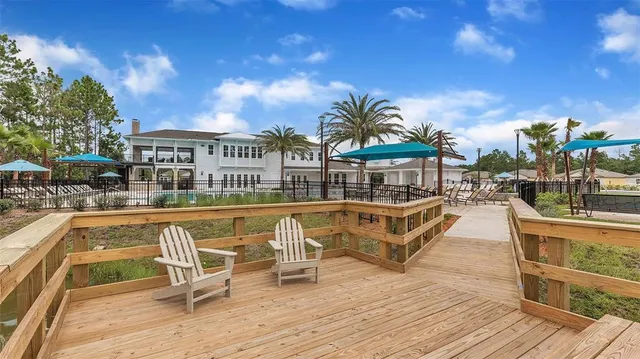 a swimming pool with outdoor seating and yard