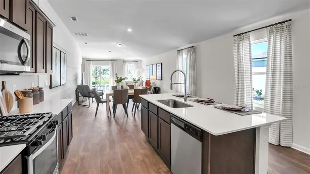 a kitchen with sink stove and cabinets