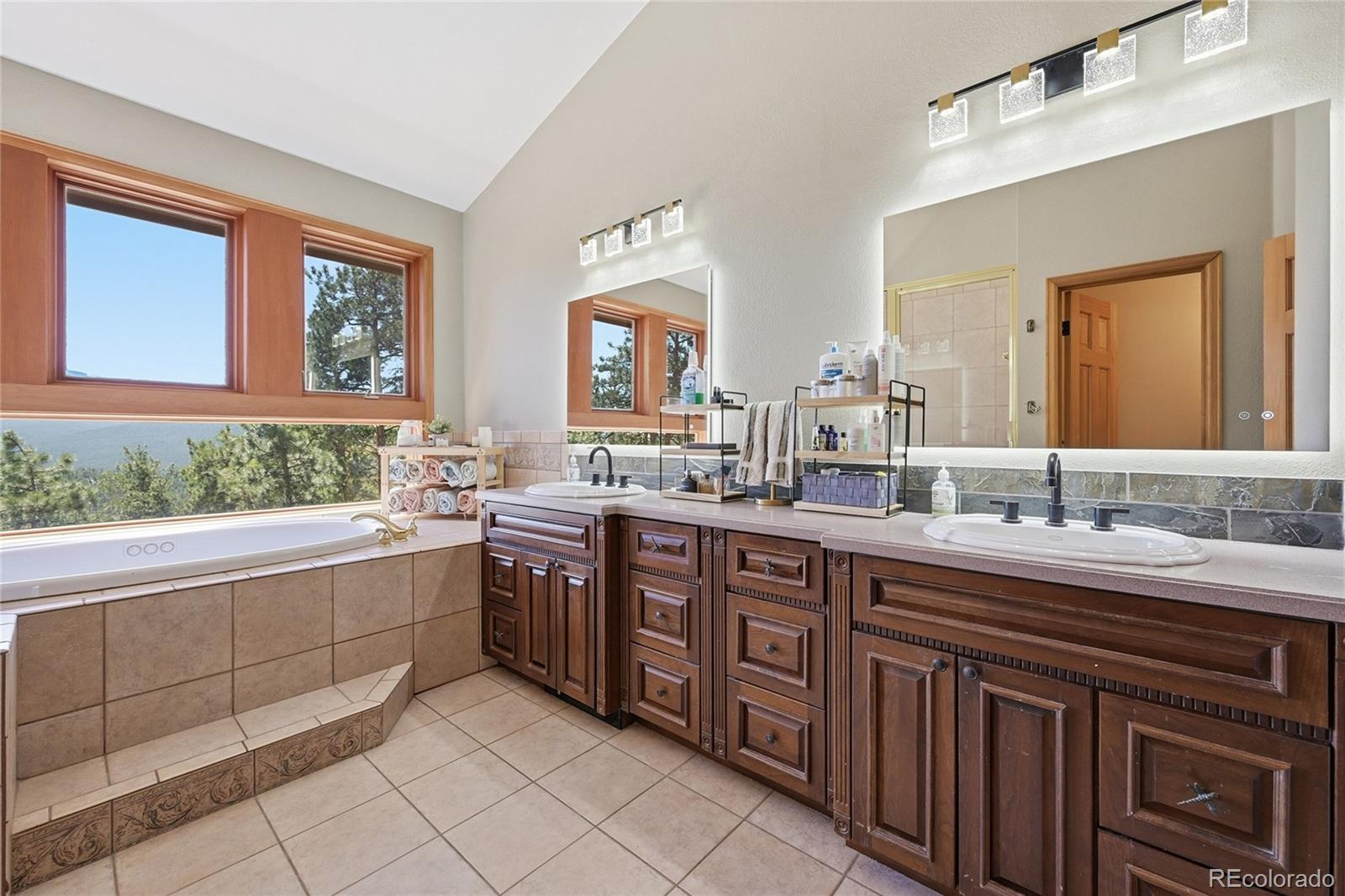 16 Auk Lane Bailey, CO 80421 - Photo 15 of 39 a spacious bathroom with a granite countertop sink mirror and double