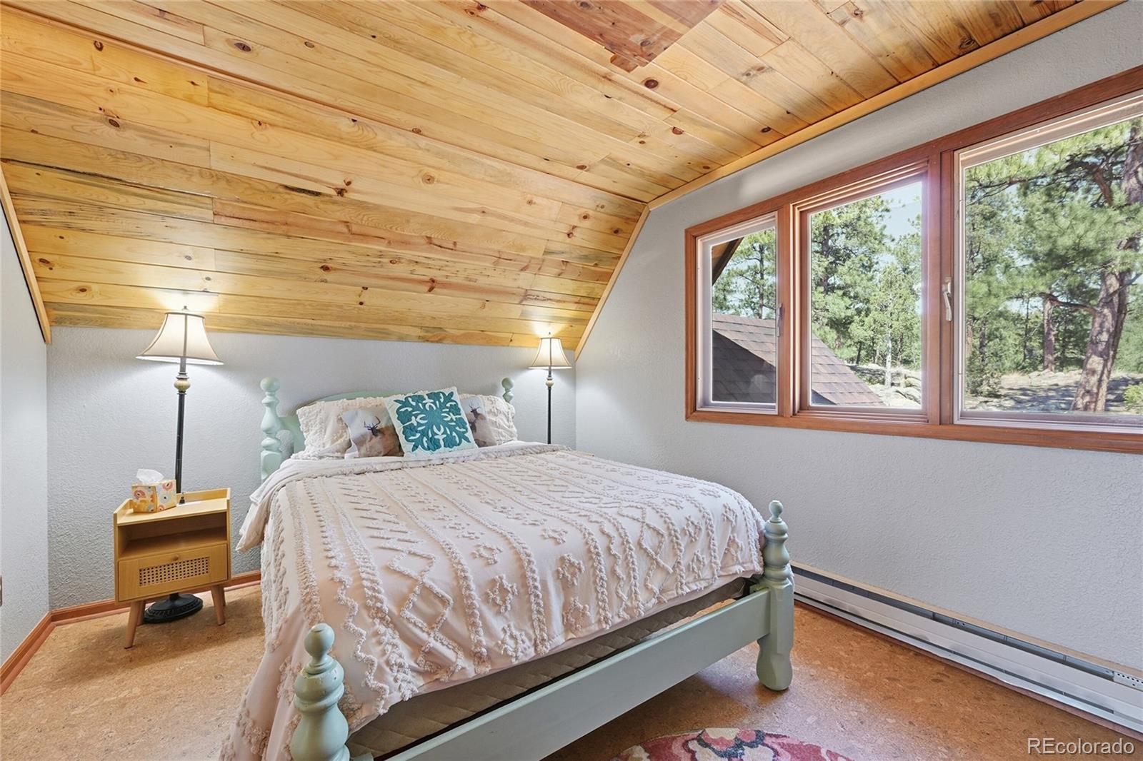 16 Auk Lane Bailey, CO 80421 - Photo 18 of 39 a bedroom with a bed and wooden floor