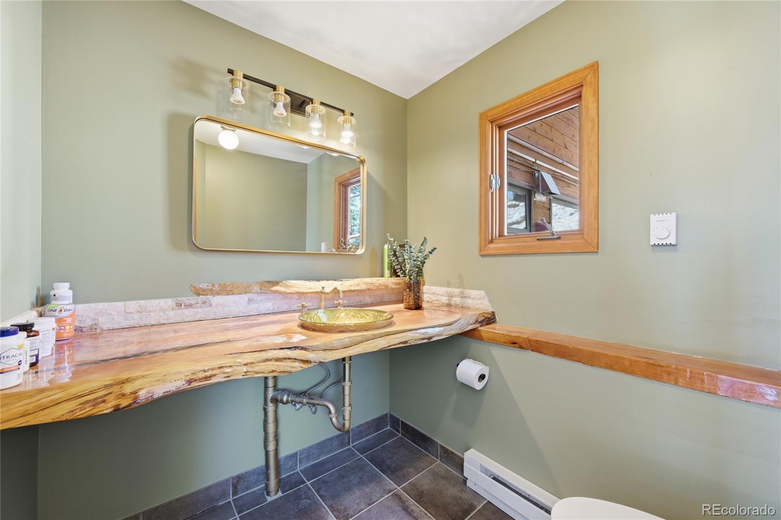 16 Auk Lane Bailey, CO 80421 - Photo 21 of 39 a bathroom with a sink and a mirror