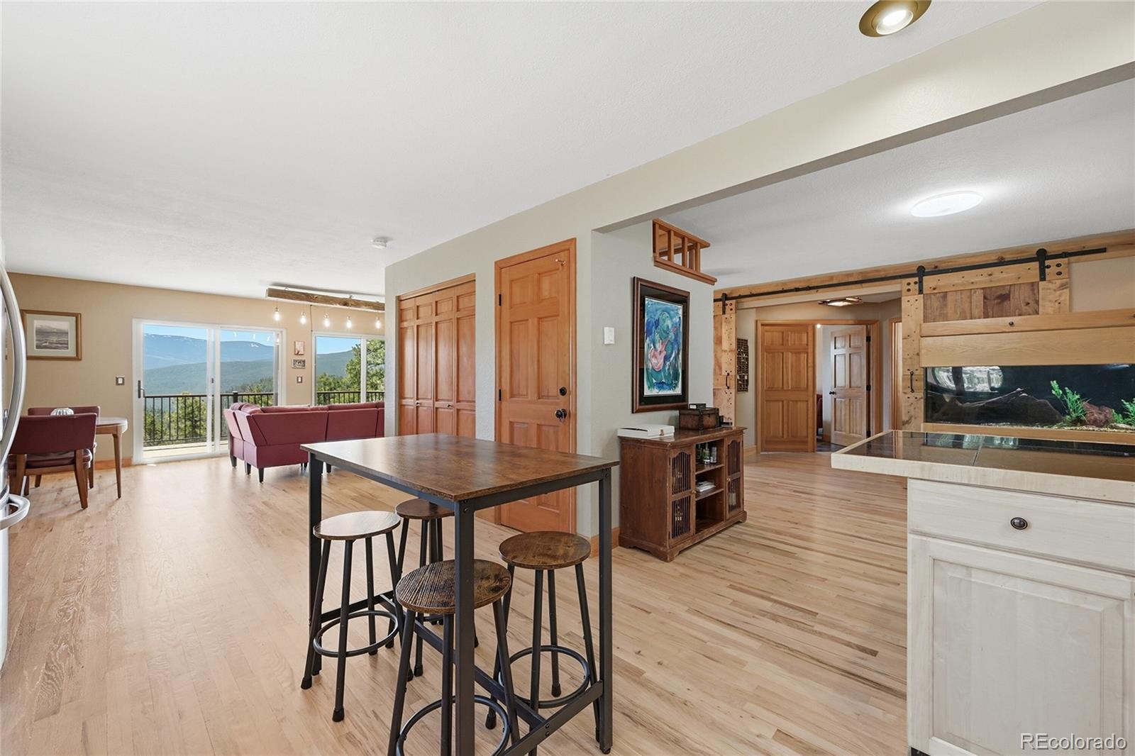 16 Auk Lane Bailey, CO 80421 - Photo 5 of 39 an open kitchen with dining table and chairs