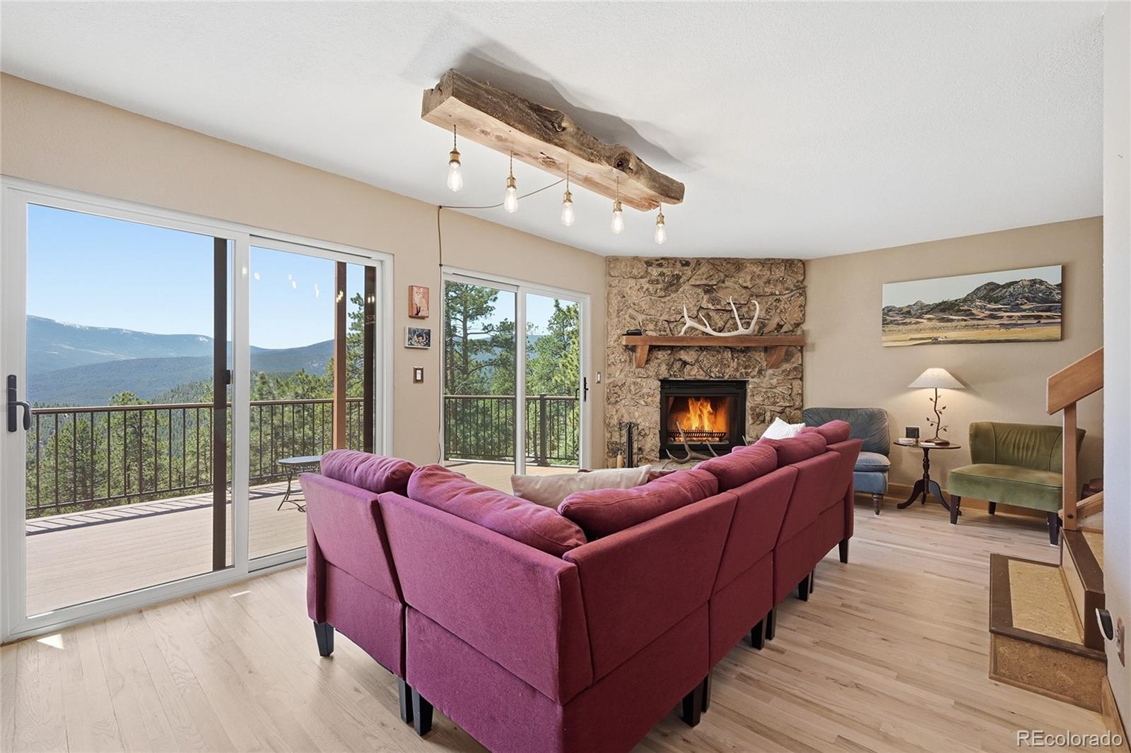 16 Auk Lane Bailey, CO 80421 - Photo 6 of 39 a living room with furniture large windows and wooden floor