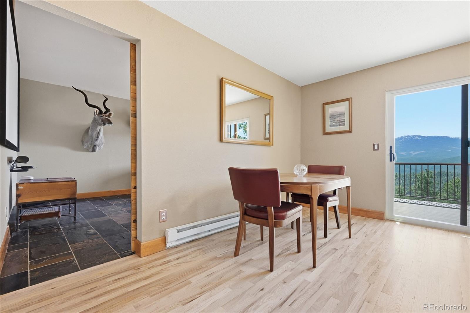 16 Auk Lane Bailey, CO 80421 - Photo 9 of 39 a view of a dining room with furniture and wooden floor