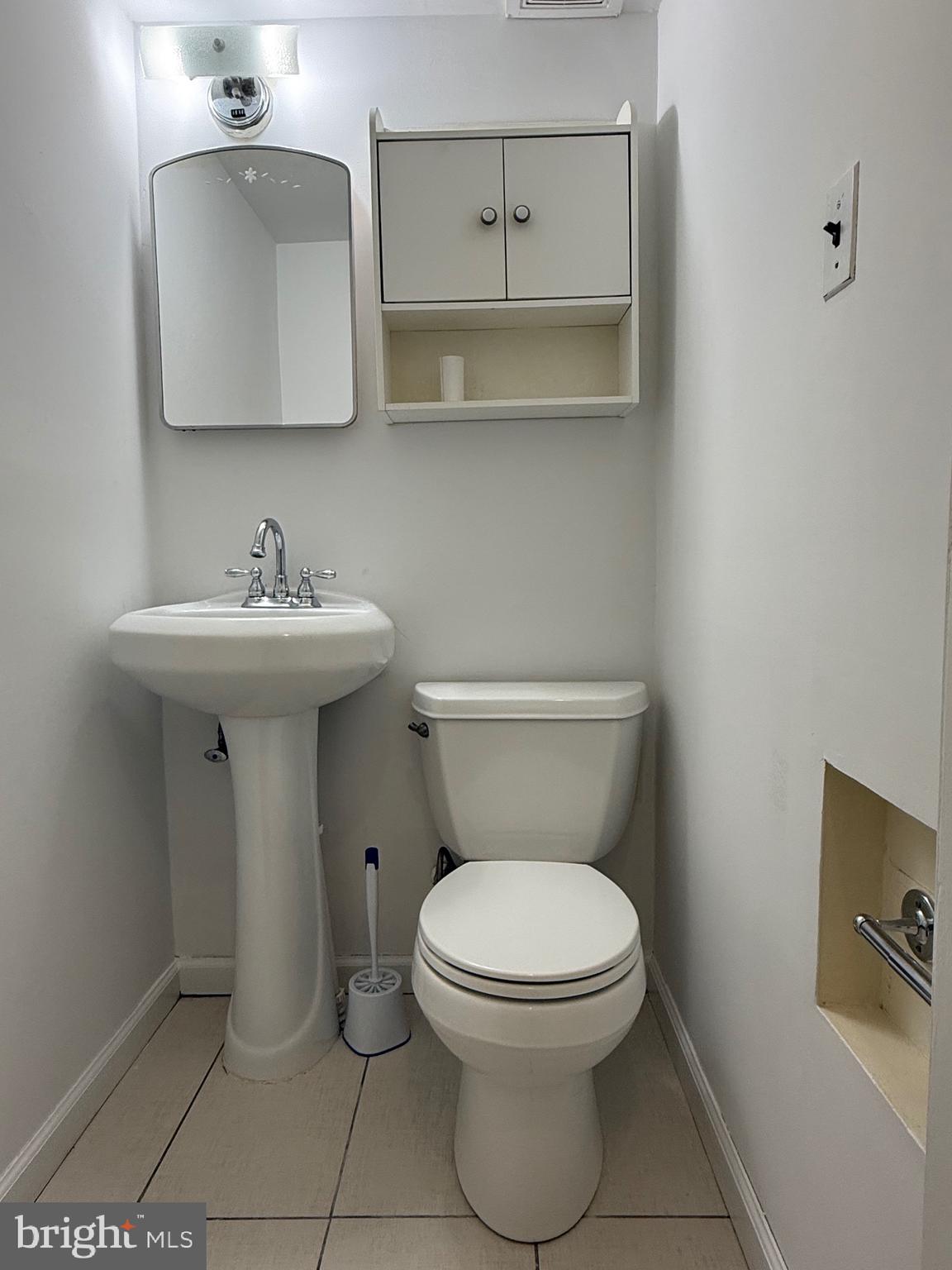 9083 Convent Avenue Philadelphia, PA 19136 - Photo 9 of 22 a bathroom with a toilet sink and mirror