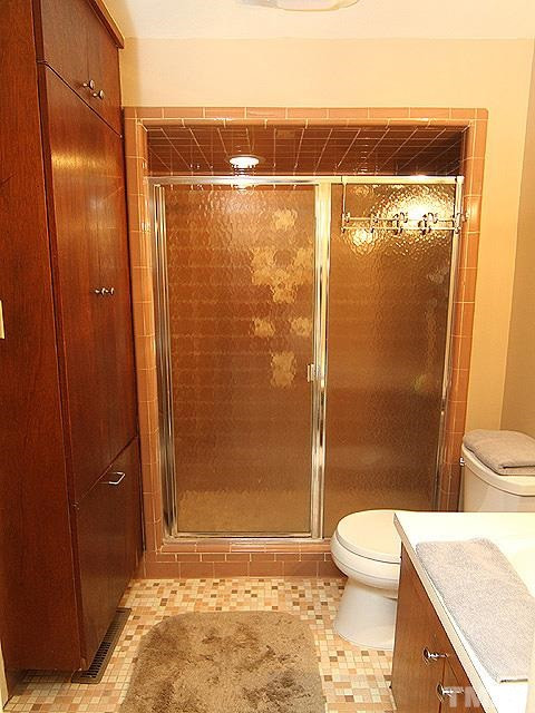 4901 Rembert Drive Raleigh, NC 27612 - Photo 13 of 25 Another vanity awaits inside the doorway, along with a toilet and walk in shower. Master Bathroom