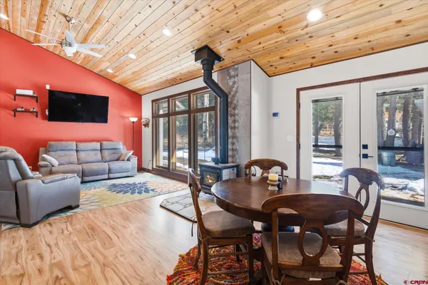 a view of a dining room with furniture and a chandelier