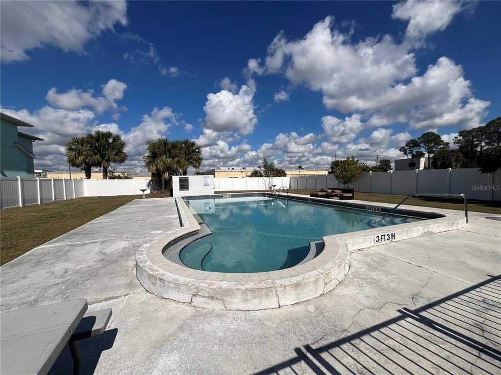 a view of a swimming pool with a yard