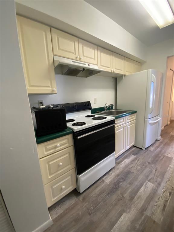 22302 Vick Street, Unit 112 Punta Gorda, FL 33980 - Photo 3 of 10 a kitchen with stainless steel appliances granite countertop a stove and a refrigerator